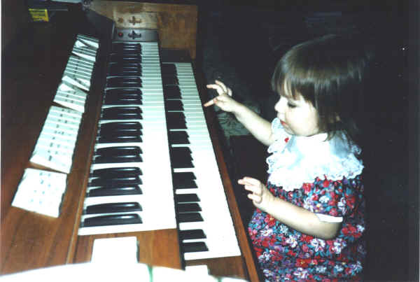 Merina (Brittany) Gordon playing the organ at 2.