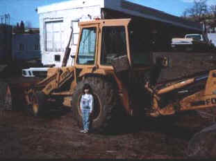 At 6 years old, Brittany was only knee high to a back-hoe.