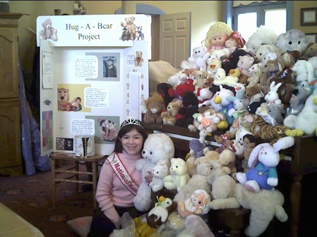 Brittany Gotrdon posing with some of the stuffed animals she collected for her Hug-A-Bear project in 2003.