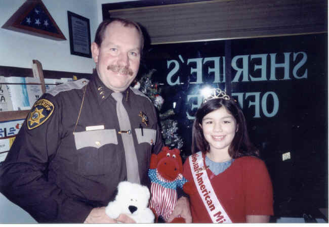 Brittany is donating part of her Hug-A-Bears to Asotin County Sheriff Wayne Weber.
